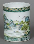 A Chinese famille verte brush pot Decorated in the round with villagers amongst a mountainous and