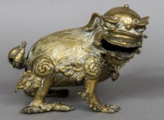 A Chinese antique bronze model of a dog-of-fo Modelled with a bell and chain around its neck,
