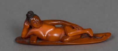 A Chinese carved horn figure of a reclining nude woman, possibly a medical figure 10.25 cm long.