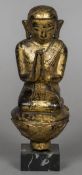 Two Eastern carved giltwood figures One formed kneeling at prayer,