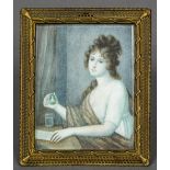 A 19th century miniature portrait on ivory Depicting a young girl at a writing desk holding a