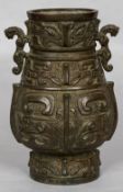 An archaistic style Chinese patinated bronze vase With twin mythical beast handles above rows of