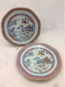 A pair of Chinese porcelain plates Each centrally decorated with a fenced garden river landscape.