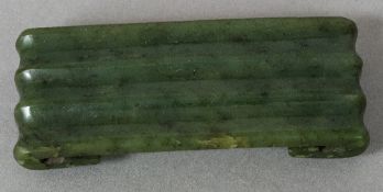 A Chinese jade belt hook Of rectangular ribbed form. 10.5 cm long.
