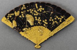 A 19th century Japanese Komai type brooch Formed as a fan decorated with cranes amongst foliage.