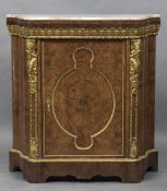 A 19th century marble topped ormolu mounted amboyna pier cabinet The shaped variegated marble top