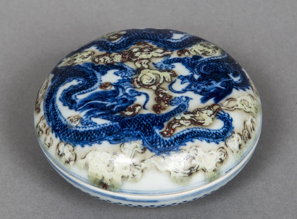 A Chinese porcelain circular box and cover Decorated with dragons chasing a flaming pearl,
