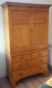 A George III pine linen press The top with twin panelled doors enclosing four slides,