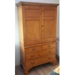 A George III pine linen press The top with twin panelled doors enclosing four slides,