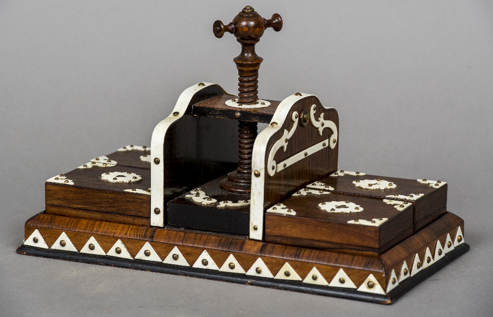 A Victorian ivory mounted rosewood press With central turning screw flanked by four boxes,