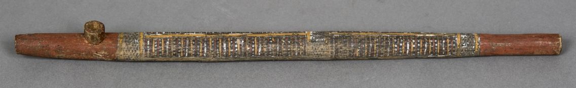 An Aboriginal pipe Of elongated tubular form with painted decorations. 55 cm long.