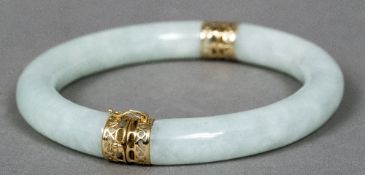 A Chinese 14 K gold mounted jade bangle Of hinged tubular form. 8 cm wide.