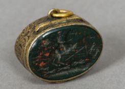 An 18th/19th century silver gilt bloodstone mounted intaglio carved fob pill box Of oval form,