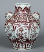 A Chinese porcelain twin handled vase Worked in iron red with floral vignettes. 19.5 cm high.