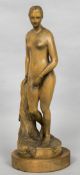 A late 19th century carved wooden model of a female nude Standing before a pillar wearing only