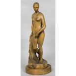 A late 19th century carved wooden model of a female nude Standing before a pillar wearing only