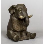 A late 19th/early 20th century novelty inkwell Formed as an elephant wearing a bib. 13.5 cm high.