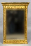 A 19th century Egyptian revival gilt framed pier glass The rectangular plate with griffin moulded