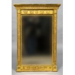 A 19th century Egyptian revival gilt framed pier glass The rectangular plate with griffin moulded