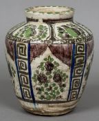 An antique Iznik style pottery vase Of ovoid form, decorated with bird and foliate filled vignettes.