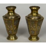 A pair of Eastern white and yellow metal inlaid brass vases Of hexagonal section,