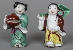 Two 19th century Chinese porcelain incense stick holders One formed as a partially robed man