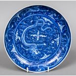 A Chinese porcelain blue and white dish Decorated with dragons amongst stylised clouds,