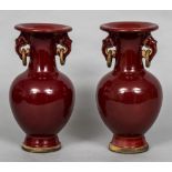 A pair of Chinese porcelain twin handled vases With allover sang de boeuf glaze,