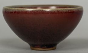 A Chinese Jun ware bowl Of conical form with ox blood glaze. 9 cm diameter.