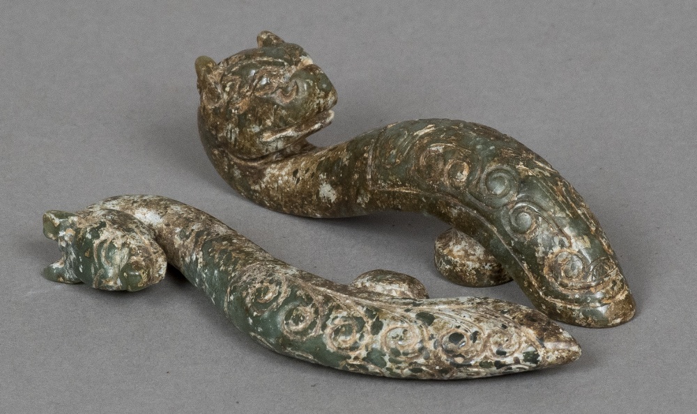 Two jade buckles Each formed as a dragon. The largest 11.5 cm high.