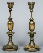 A pair of Japanese white and yellow metal in bronze candlesticks Worked with floral sprays.