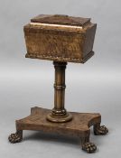 A 19th century pollard oak teapoy The hinged sarcophagus top enclosing twin lidded compartments and