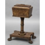 A 19th century pollard oak teapoy The hinged sarcophagus top enclosing twin lidded compartments and