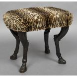 An 18th/19th century carved oak foot stool The leopard fur upholstered top above the carved legs