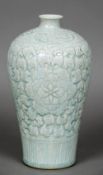 A Chinese celadon vase Of tapering bulbous form, decorated in the round with chrysanthemums. 27.