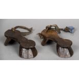 A pair of antique carved wooden Indo-Portuguese stilted shoes Of typical form with rope and leather