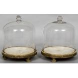A pair of early 19th century glass domes Each with a knop finial,