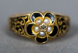 A 19th century 18 ct gold mourning ring Set with seed pearls and with enamel decorations.