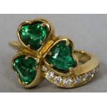 A gold, emerald and diamond set ring Worked as a three leaf clover.