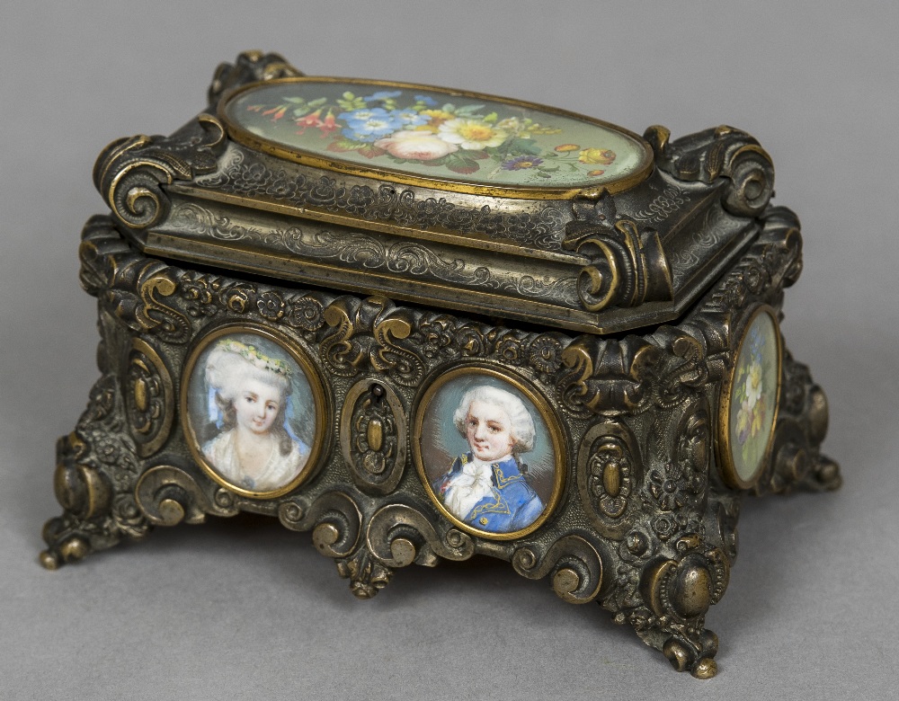 A 19th century painted miniature inset bronze casket The hinged lid inset with a floral miniature,