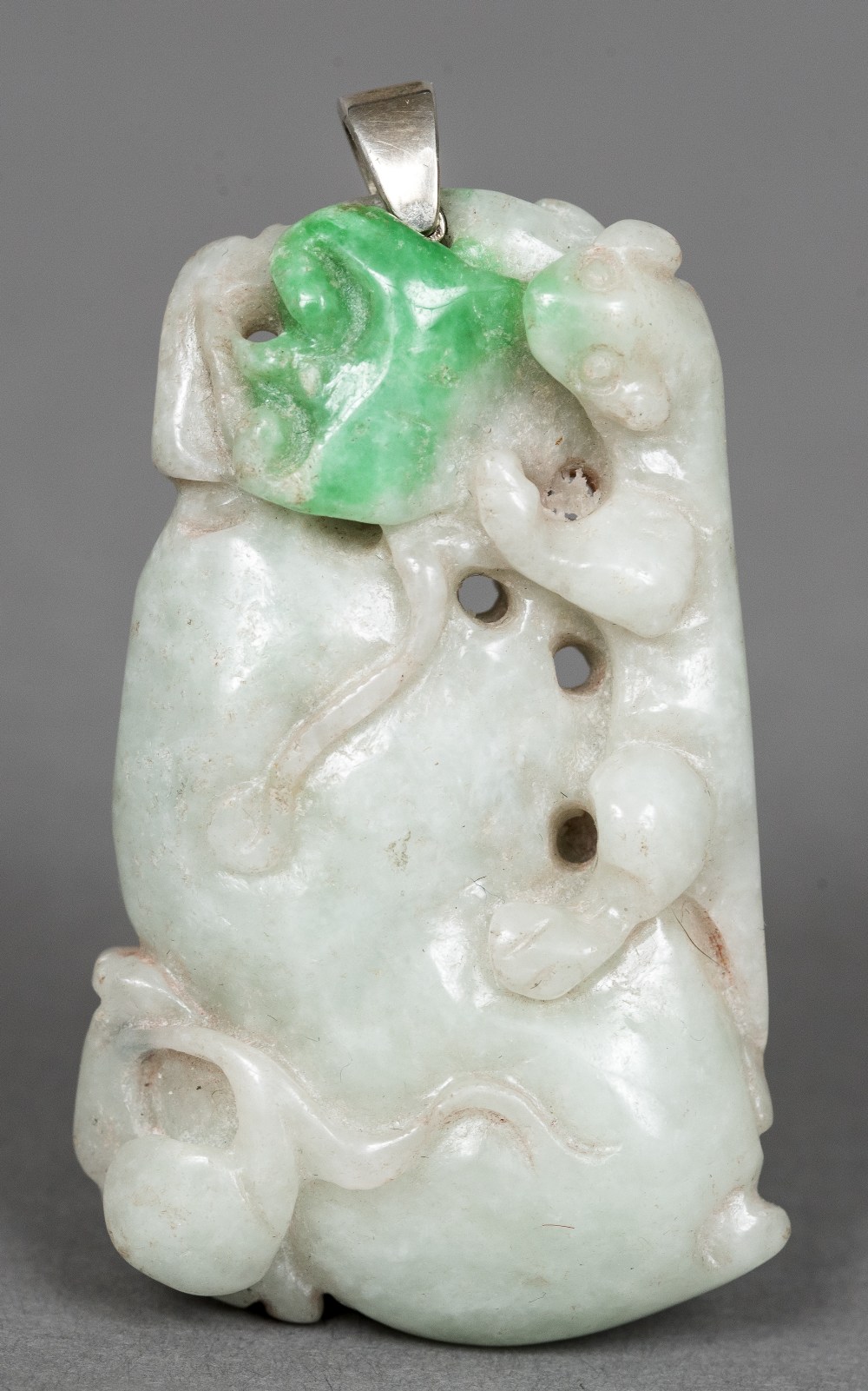 A Chinese carved jadeite pendant Worked with a salamander. 6 cm long.