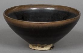 A Chinese pottery footed bowl Decorated with a hare's fur type glaze. 17.5 cm diameter.