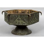 An Arts & Crafts copper jardiniere Of hexagonal font form with stylised foliate decoration.