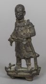 A Chinese Ming patinated bronze model of an official Modelled standing holding a bell,