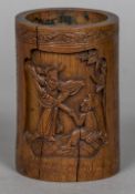 A 19th century Chinese carved bamboo brush pot Decorated with figural vignettes and calligraphy.