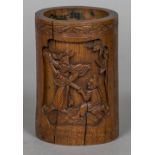 A 19th century Chinese carved bamboo brush pot Decorated with figural vignettes and calligraphy.