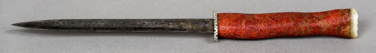 An antique dagger The handle formed from a piece of red coral with a mother-of-pearl terminal.