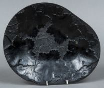 An unusual 19th century dish, possibly slate Worked with foliate vines. 30 cm wide.