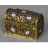 A 19th century French gilt bronze casket Of pierced scrolling hinged domed form set with Sevres