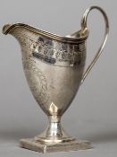 A George III silver cream jug, hallmarked London 1799,